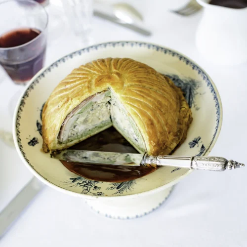 Tourte de canard et foie gras, sauce Grand Veneur du Menu - Scorpio, présenté découpée dans une belle assiette et avec un beau couteau dans une ambiance "Grand Siècle"