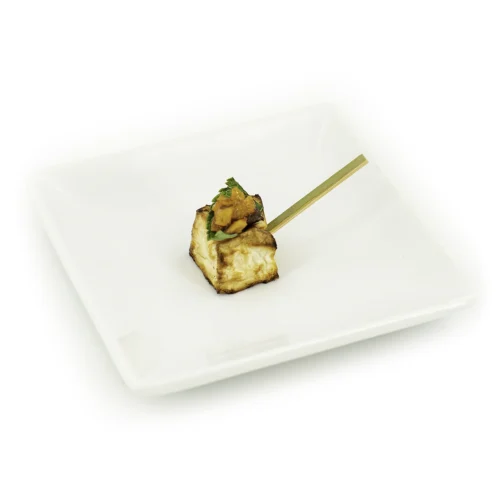 Céleri à l'oriental dans une assiette sur fond blanc